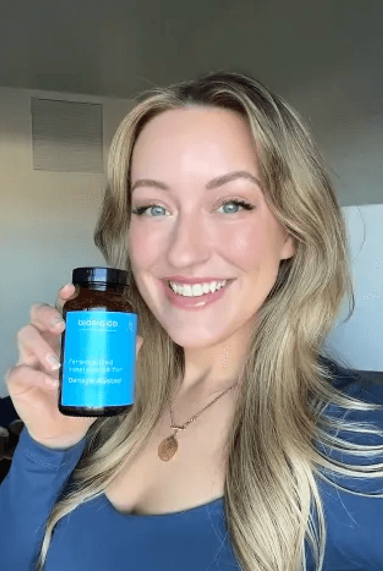Woman smiling holding Bioniq bottle